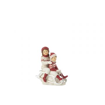 Fille et garçon sur traîneau blanc/rouge